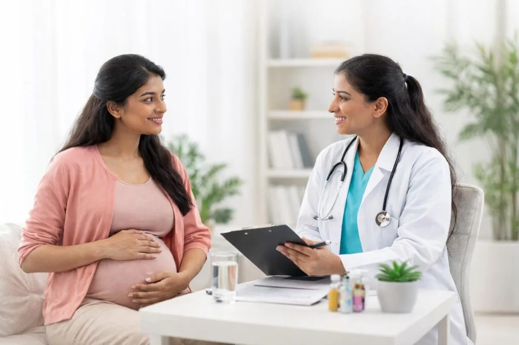 Pregnant woman discussing her pregnancy with a doctor during a consultation